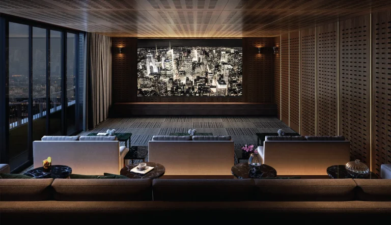 Noble Form Thonglor luxury condo private cinema room featuring tiered plush seating, a large viewing screen, and acoustic wood paneling on Sukhumvit 55 Bangkok