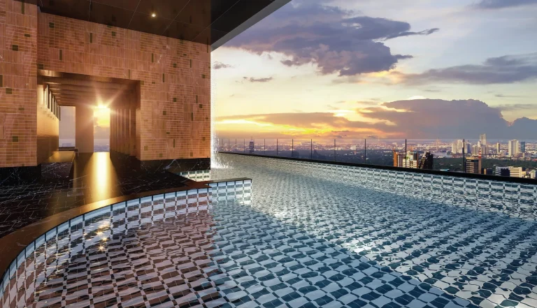 Noble Form Thonglor luxury condo 45th-floor Sky Lagoon infinity swimming pool overlooking a dramatic sunset over the Bangkok city skyline on Sukhumvit 55